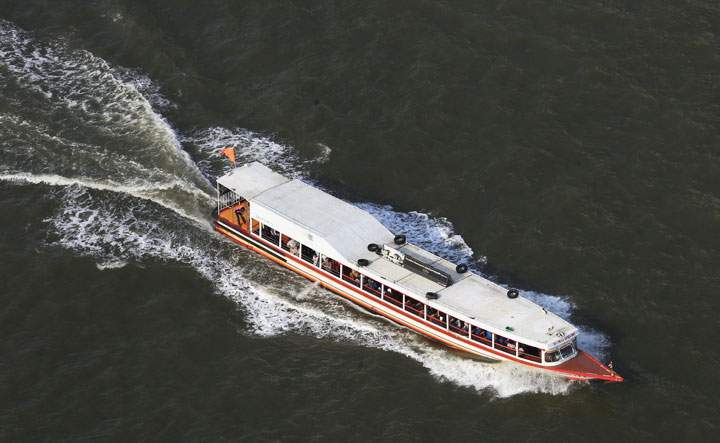A water taxi travels on the Chao Phraya River, running through the Thai capital of Bangkok, in Bangkok, Thailand, on May 13, 2016.