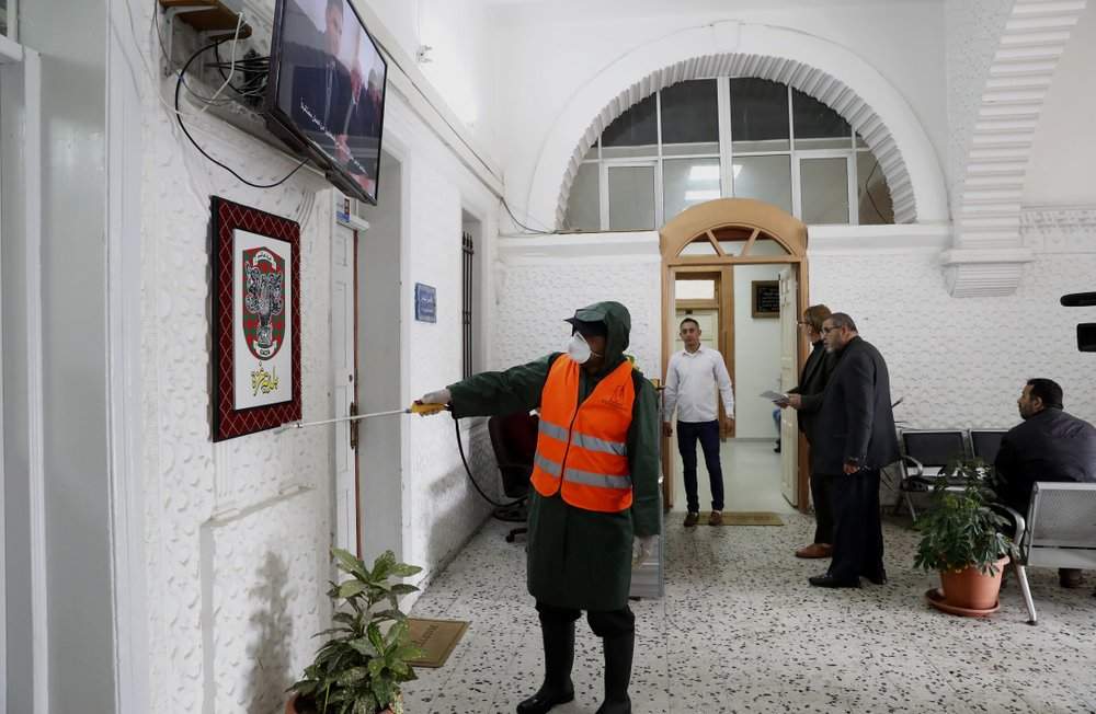 A worker wearing protective gear disinfects the offices at the building of Gaza municipality to help prevent the spread of the new coronavirus, in Gaza City, Tuesday, March 10, 2020. For most people, the new coronavirus causes only mild or moderate symptoms, such as fever and cough. For some, especially older adults and people with existing health problems, it can cause more severe illness, including pneumonia. 