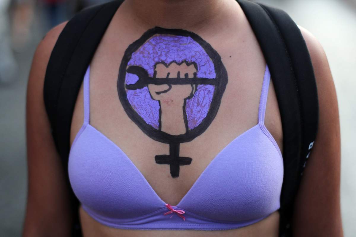 A woman with body paint on her chest marches during the 2018 International Women’s Day protest to demand equal rights in Santiago, Chile. EPA/MARIO RUIZ