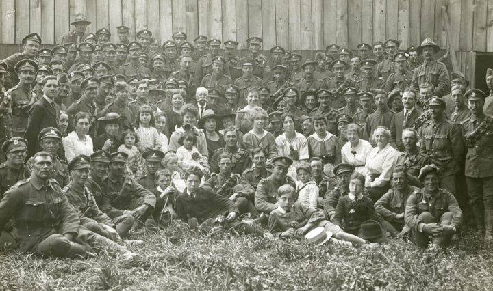 Group photo of a group of men in military uniform, along with civilians. July 25, 1918.