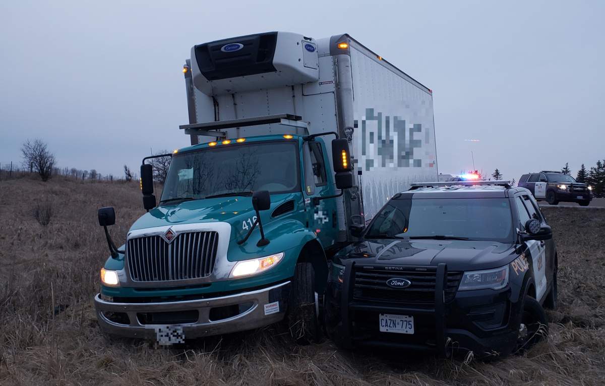 Police say the truck entered the ditch after losing one its front tires on a spike belt.