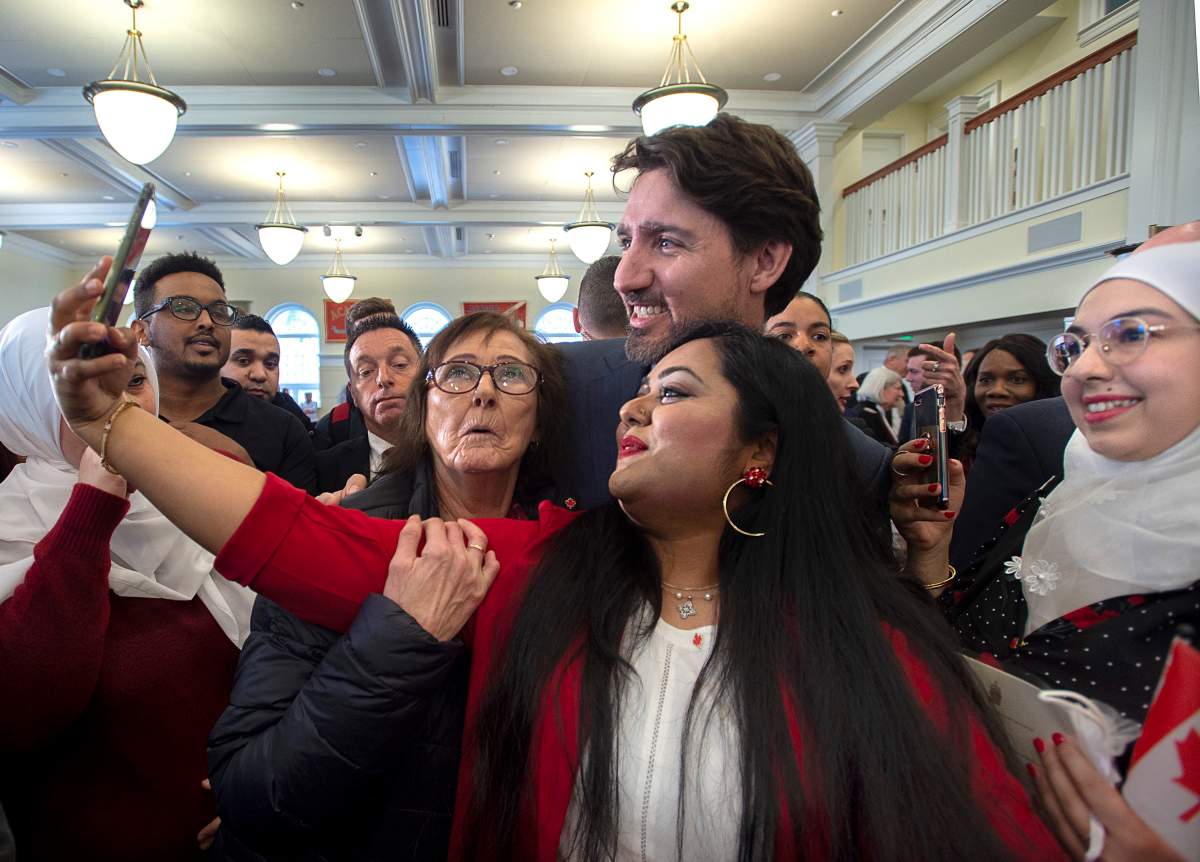 Prime Minister Justin Trudeau poses for photos with new Canadians as he attends a citizenship ceremony at Acadia University in Wolfville, N.S. on Tuesday, March 3, 2020. THE CANADIAN PRESS/Andrew Vaughan