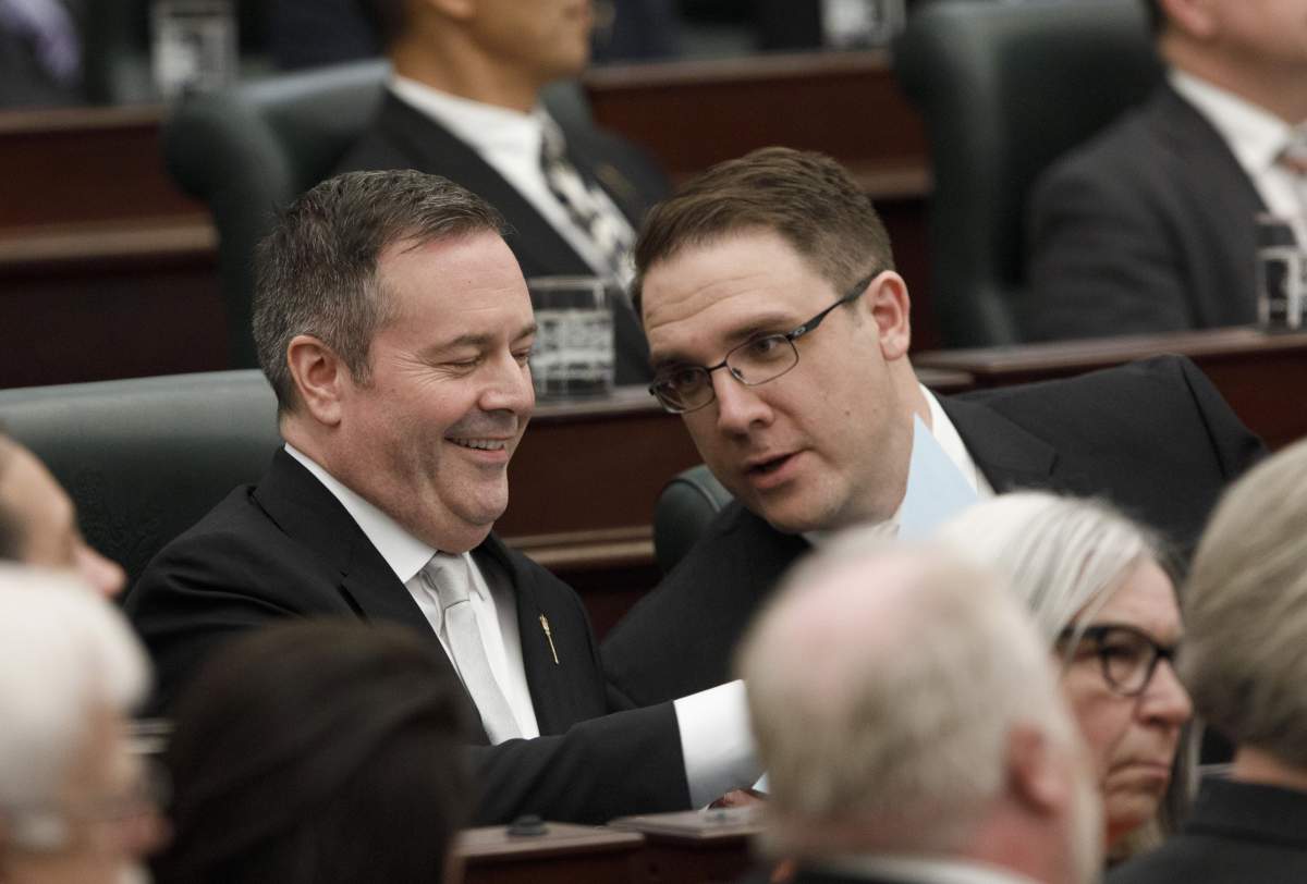 Alberta Premier Jason Kenny Jason Nixon Minister of Environment and Parks chat before the speech from the throne is delivered in Edmonton Alta, on Tuesday May 21, 2019. 