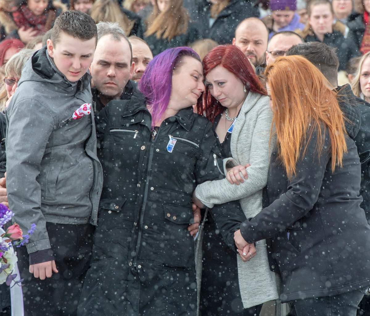 Francis Boyer and Caroline Sarrazin, parents of Oceane Boyer, 13, hug their children after a funeral service for their daughter, Friday, March 6, 2020 in Lachute, Que. Boyer was murdered last week while walking to school.THE CANADIAN PRESS/Ryan Remiorz