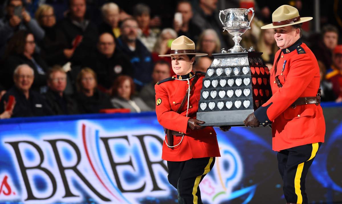 Mounties carry in the Brier Tankard trophy during the Brier curling final between Team Alberta and Team Newfoundland and Labrador in Kingston, Ont., on Sunday, March 8, 2020.