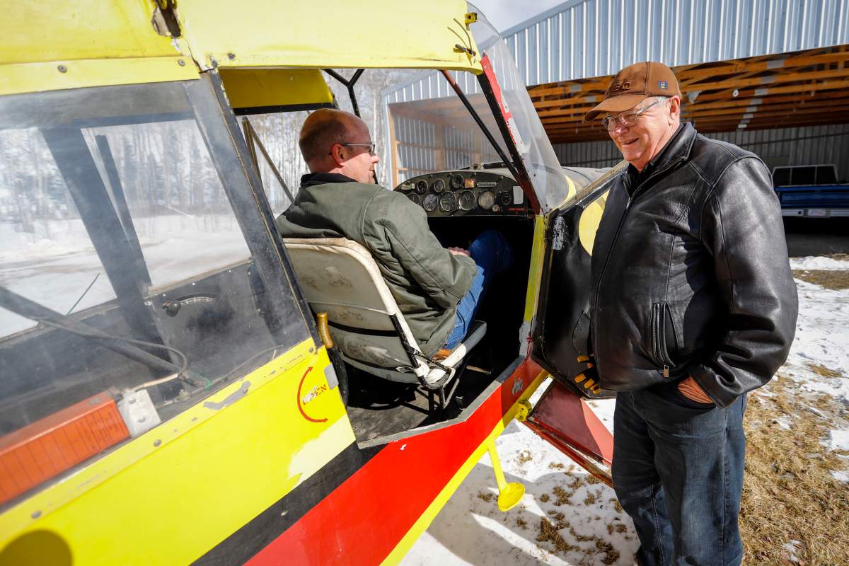 Richard Reid, right, and his son David Reid, who are both farmers and pilots, look over the plane that Richard purchased as a 17 year-old and which his son David is now restoring at their farm near Cremona, Alta., Wednesday, March 4, 2020.