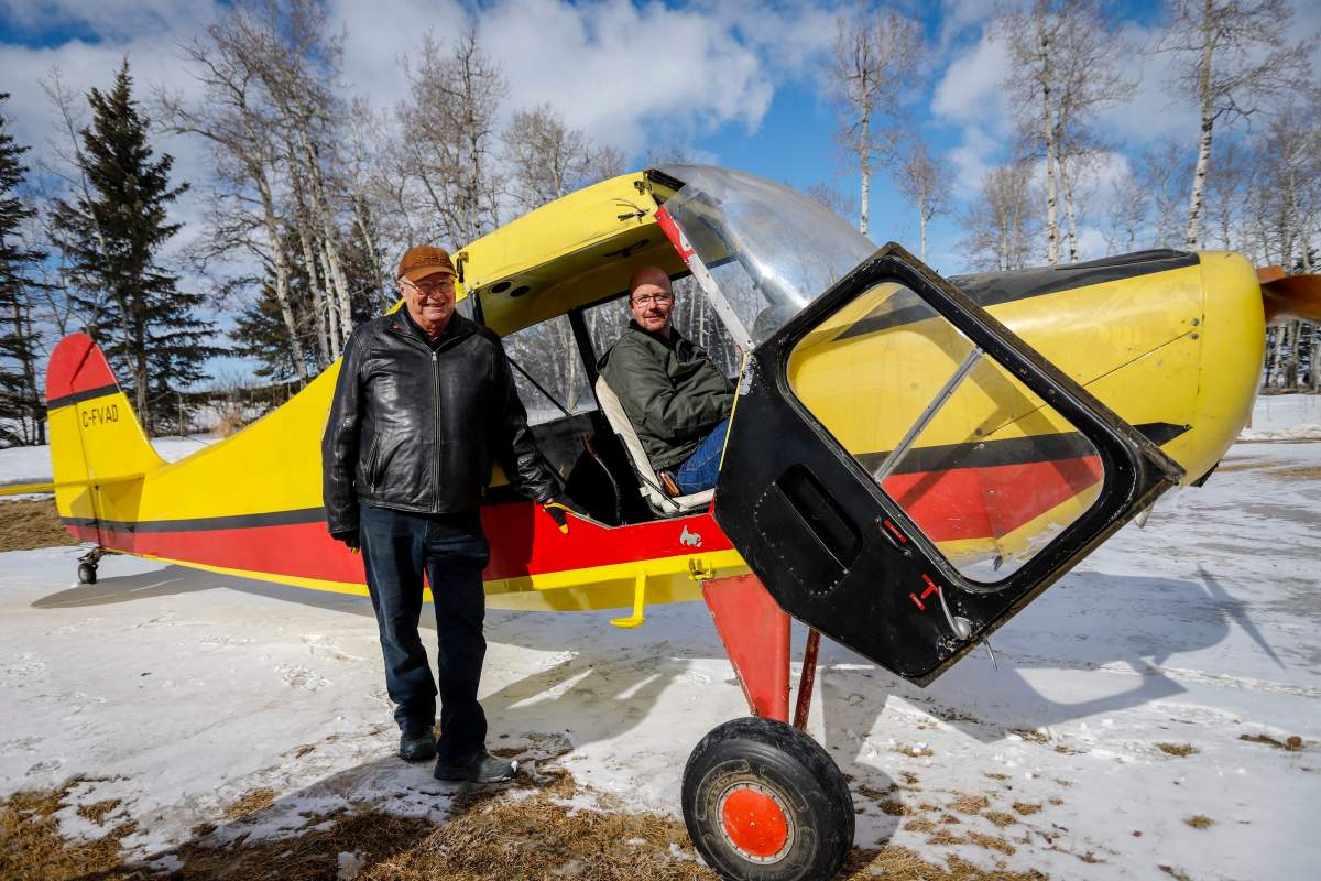 Richard Reid, left, and his son David Reid, who are both farmers and pilots, look over the plane that Richard purchased as a 17 year-old and which his son David is now restoring at their farm near Cremona, Alta., Wednesday, March 4, 2020.