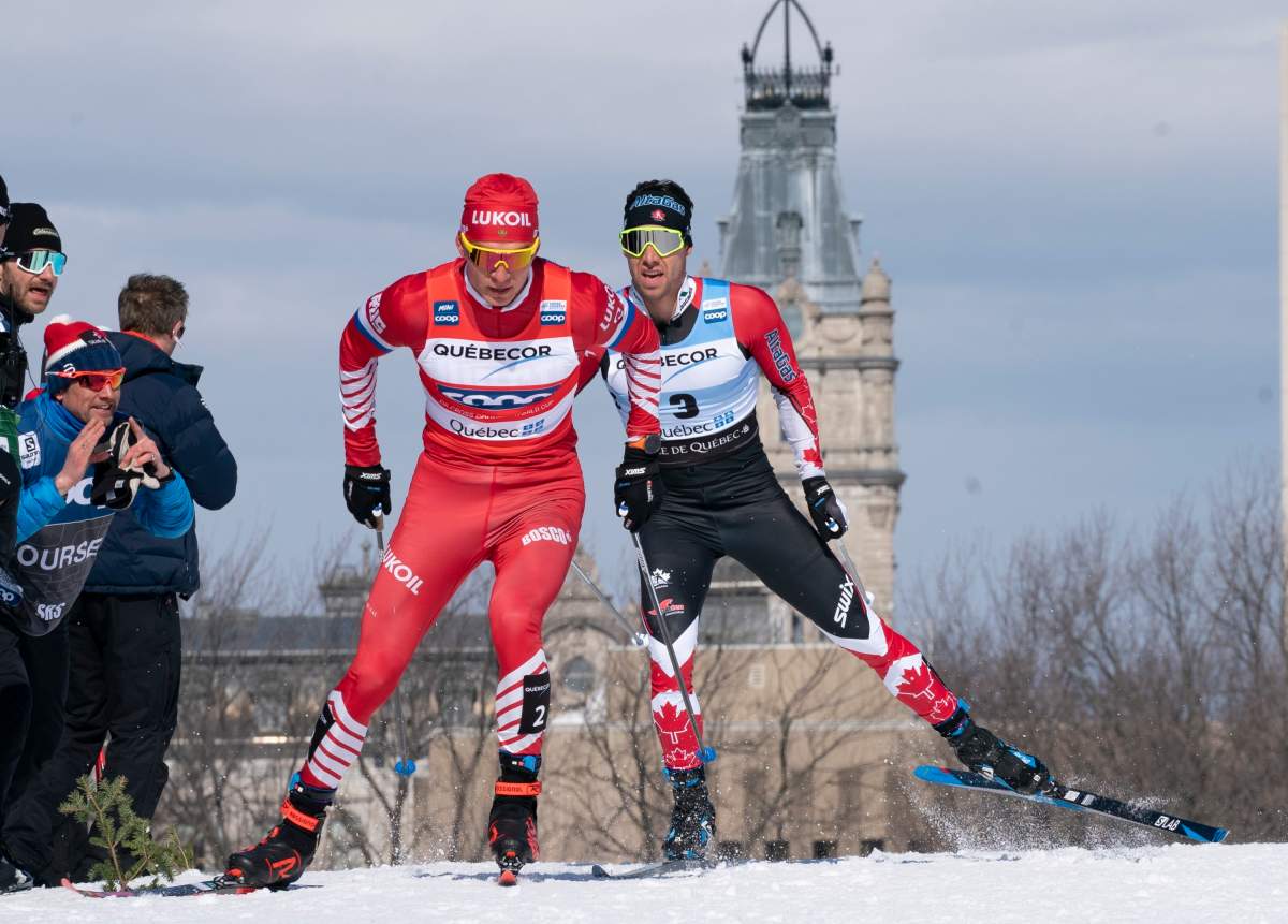 Alexander Bolshunov of Russia, left, and Alex Harvey of St-Ferreol-les-Neiges Que. race during the men's 15 km pursuit free Sunday, March 24, 2019 at the COOP FIS cross country world cup in Quebec City. The World Cup cross-country ski event this weekend in Quebec City has been cancelled because of the COVID-19 outbreak. 