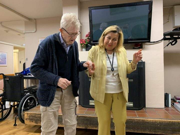 Bill Shellard, an 81-year-old resident of Lynn Valley Care Centre walks with a member of the staff in North Vancouver in this recent undated handout image provided by his daughter Kelly Shellard. 