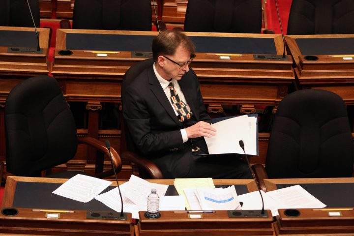 Minister Adrian Dix looks on as Premier John Horgan and a dozen MLAs who gathered in the legislative assembly to make special statements about the COVID-19 pandemic during a rare event at the Legislature in Victoria, B.C., on Monday, March 23, 2020.