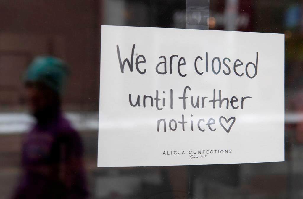 A sign on a shop window indicates the store is closed.