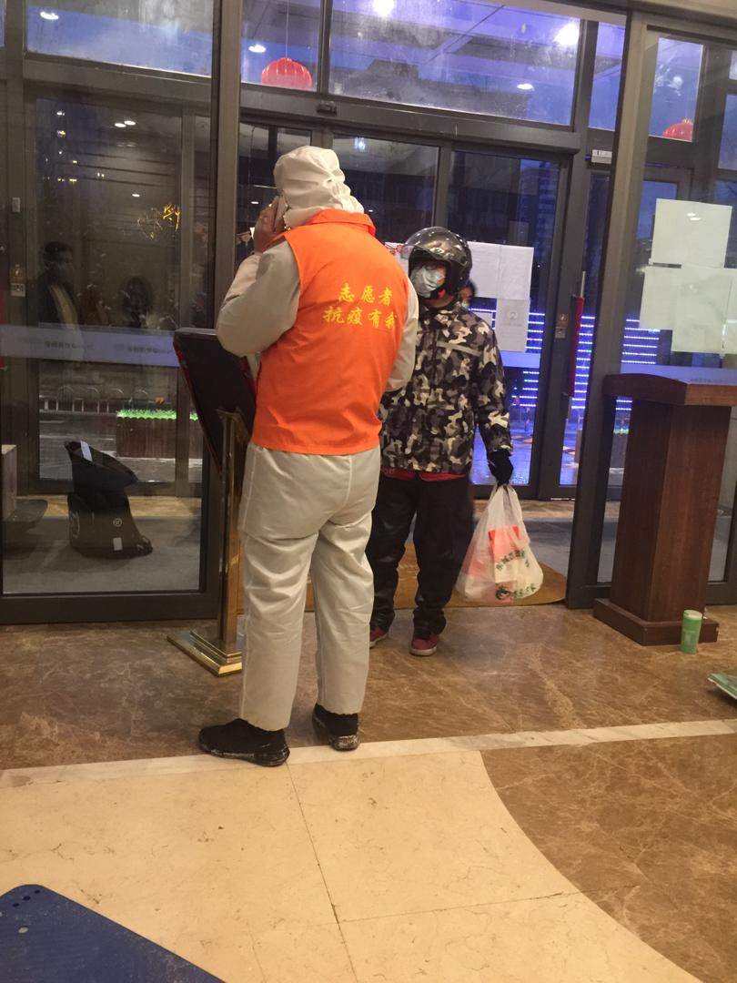 A man delivers goods to the Passafiumes’ apartment building before the metal detectors were installed.