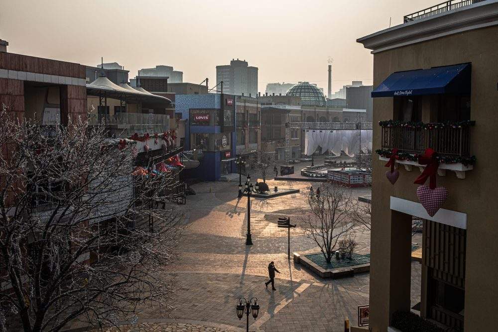 A person walks in an almost empty Solana shopping mall area in Beijing, China, Feb. 12, 2020.