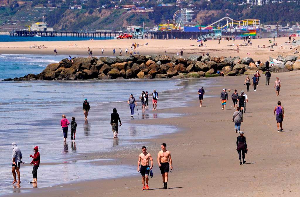 Beachgoers are seen at Venice Beach, Saturday, March 21, 2020, in Los Angeles, Calif.