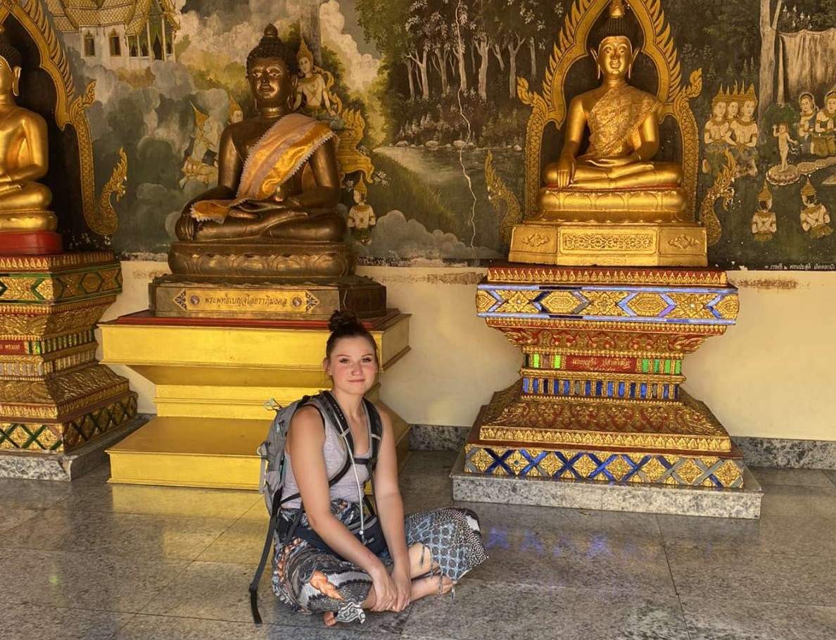Cathryn Ferster is seen sitting before an attraction in Thailand. 