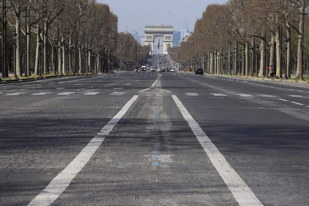 A view of the mostly empty Champs-Élysées avenue in Paris, Thursday, March 19, 2020.