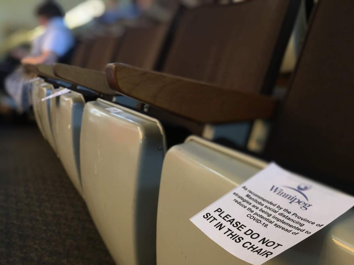 A placard warning delegates to mind social distancing protocols at a special executive policy committee meeting. Jordan Pearn/Global News.