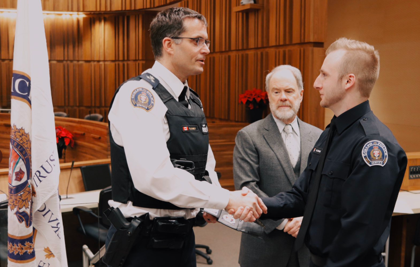 Police Chief Gord Cobey welcomes a new recruit during a swearing-in ceremony at Guelph city hall. 