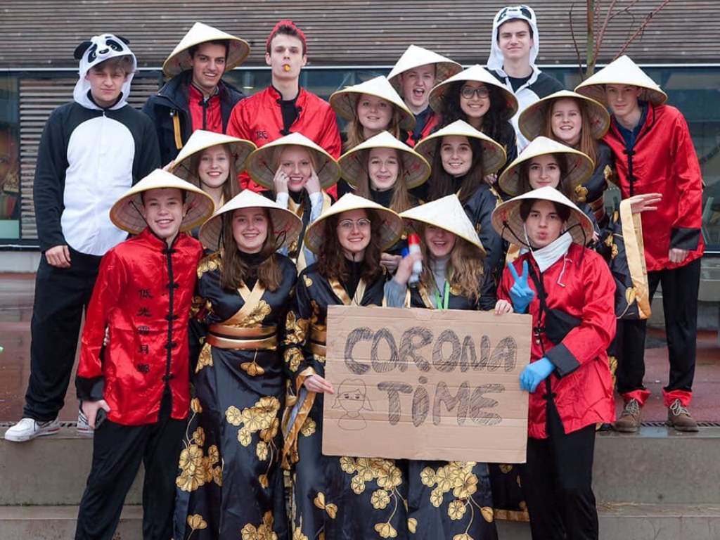 A group of Sint Paulus school students in Belgium posed in stereotypical Chinese clothing and held up a "Corona Time" sign.