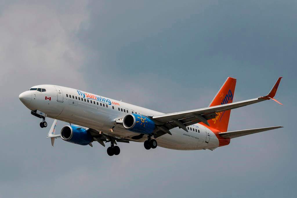 A Sunwing Boeing 737-800 passenger plane prepares to land at Pearson International Airport in Toronto on Wednesday, August 2, 2017. Sunwing Airlines Ltd. says it is offering seats on its repatriation flights free of charge to any Canadians stranded in sun-kissed parts of the hemisphere, including to non-Sunwing customers.THE CANADIAN PRESS/Christopher Katsarov.