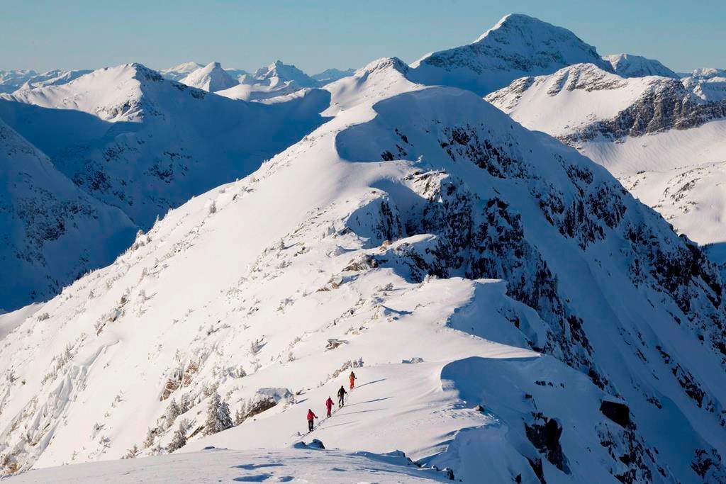 Backcountry skiers are dwarfed by the mountains as they make their way along a mountain ridge near McGillivray Pass Lodge located in the southern Chilcotin Mountains of British Columbia, on January 10, 2012. Rescue officials are asking backcountry users to choose low-risk activities as the risk for COVID-19 grows. The warning comes after the Alberta government asked ski hills in the province to close to prevent the spread of the novel coronavirus. THE CANADIAN PRESS/Jonathan Hayward.