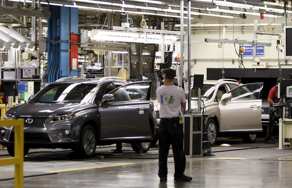 Line workers assemble a Lexus SUV at the Toyota plant in Cambridge, Ont., Friday, July 31, 2015.
