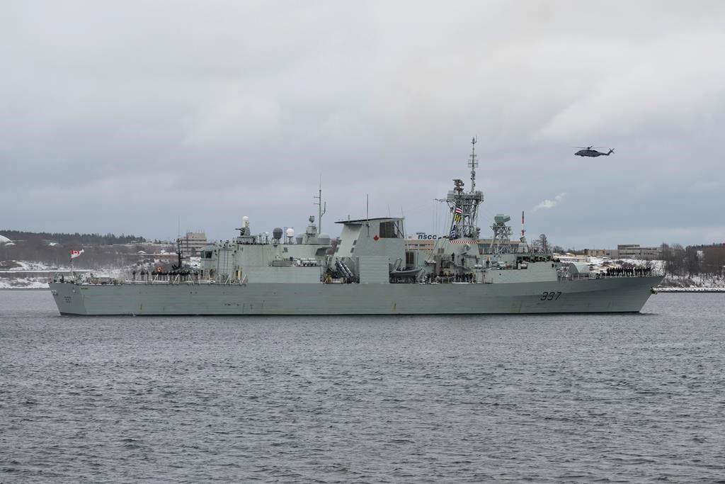 A Cyclone helicopter flies over HMCS Fredericton as its crew leaves the Halifax Harbour for a six-month deployment to the Mediterranean Sea as part of NATO's Operation Reassurance in Halifax on January 20, 2020. THE CANADIAN PRESS/Darren Calabrese.