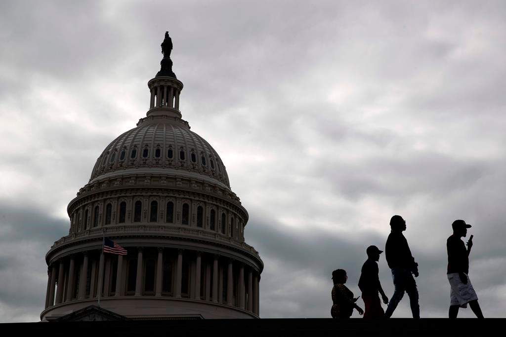 Visitors walk past the U.S. Capitol dome on Capitol Hill in Washington, March 12, 2020.