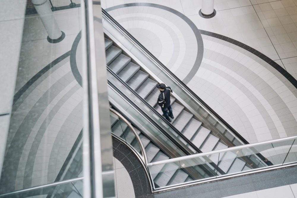 A shopper uses an escalator at the Eaton Centre in Toronto, Wednesday, March 18, 2020.