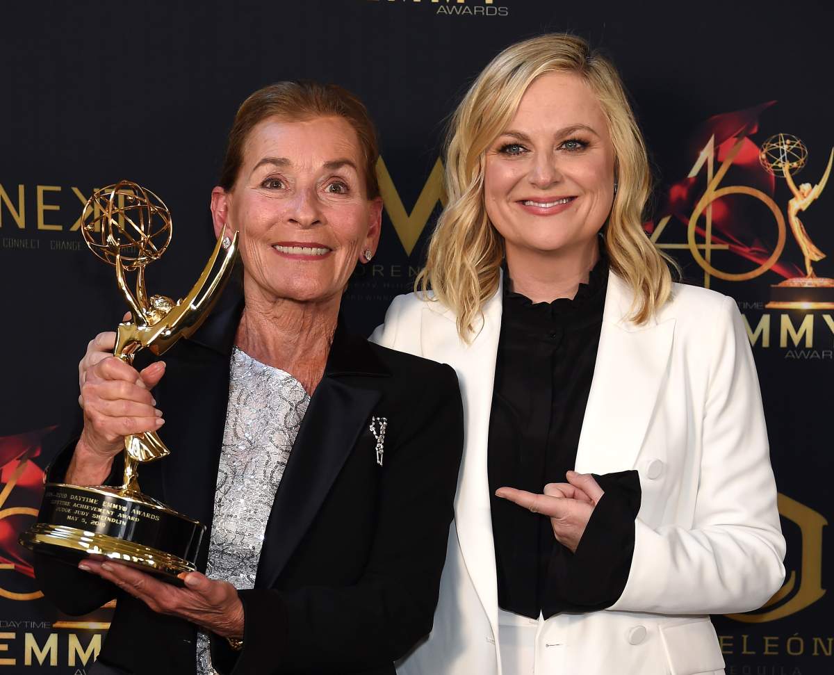 Judge Judy (L) poses with the Lifetime Achievement Award in the press room with Amy Poehler during the 46th annual Daytime Emmy Awards at Pasadena Civic Center on May 05, 2019, in Pasadena, Calif. (Photo by Gregg DeGuire/Getty Images)