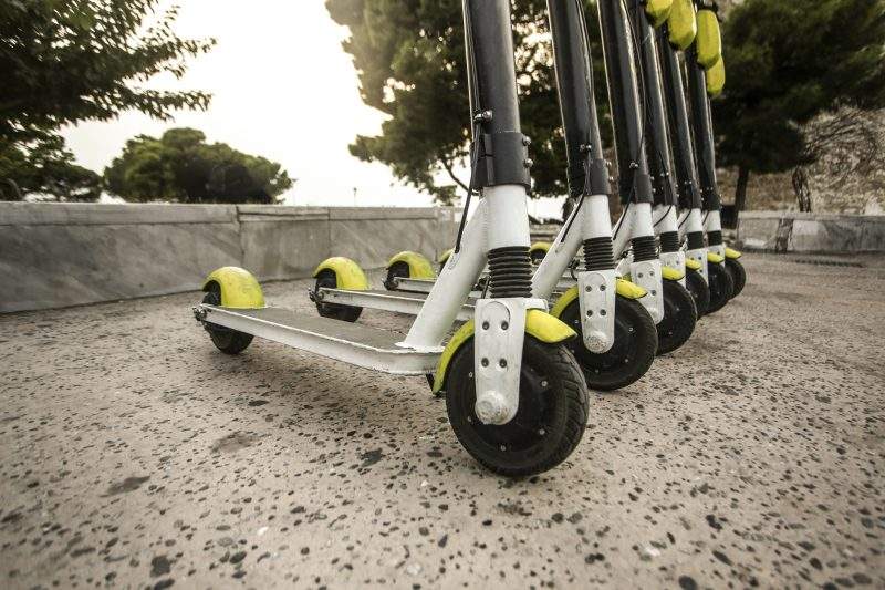 Group of electronic scooters on the street.