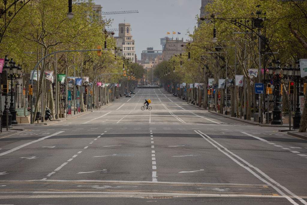A Glovo worker on a bicycle at Paseo de Gracia in Barcelona, Spain on March 23, 2020. The photo was taken during the first working day of the second week since the state of emergency was decreed.