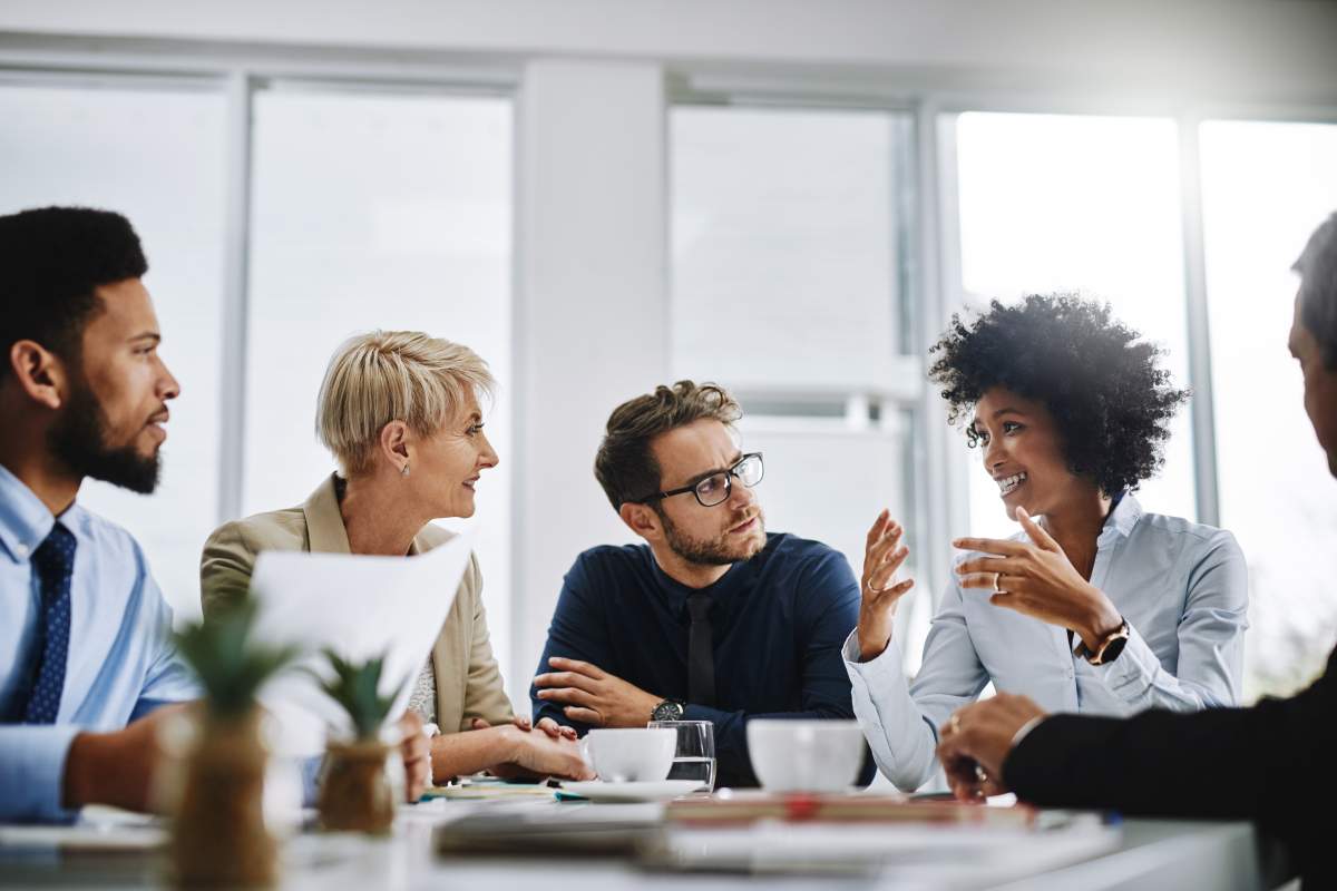 Shot of a group of businesspeople sitting together in a meeting.