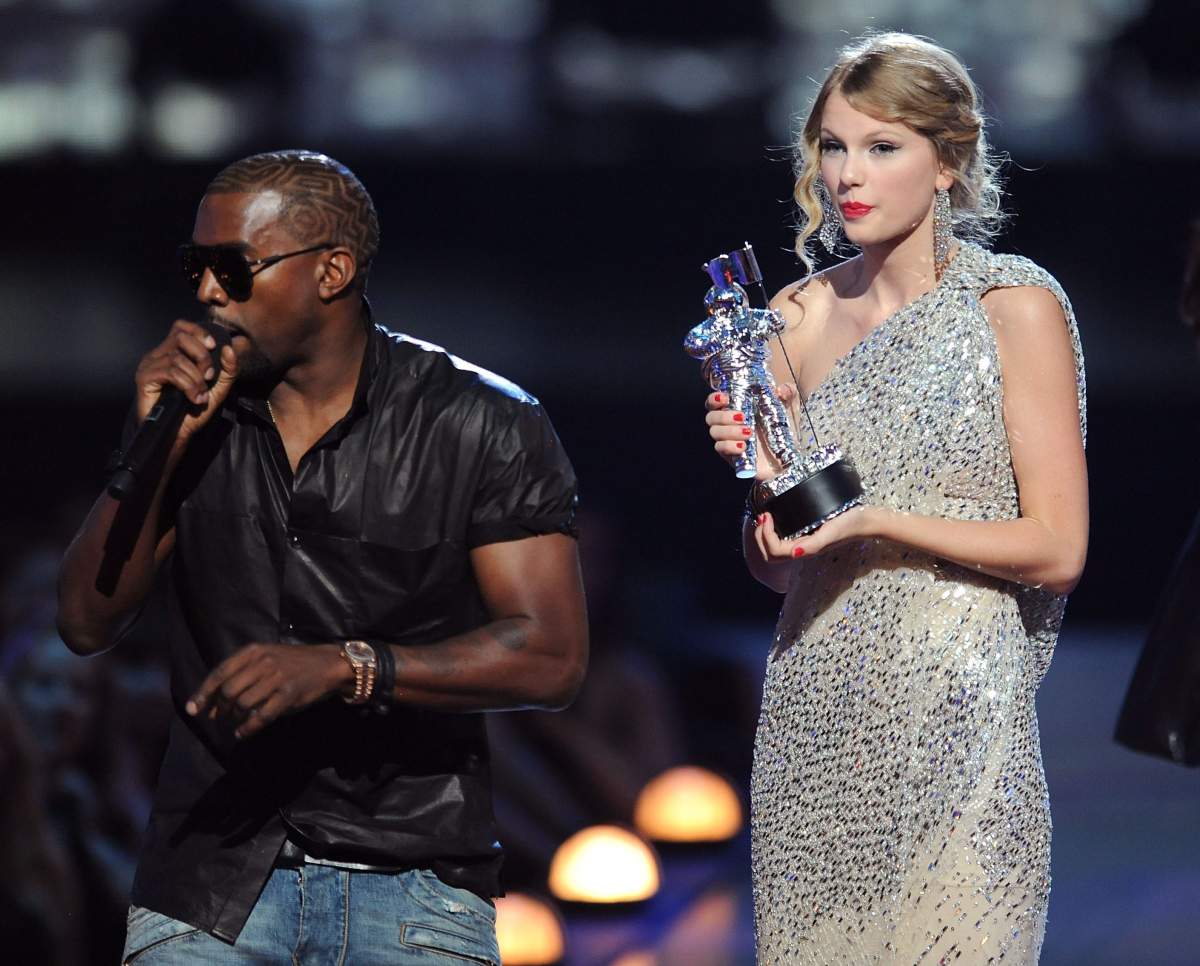Kanye West takes the microphone from Taylor Swift and speaks onstage during the 2009 MTV Video Music Awards at Radio City Music Hall on Sept. 13, 2009 in New York City.