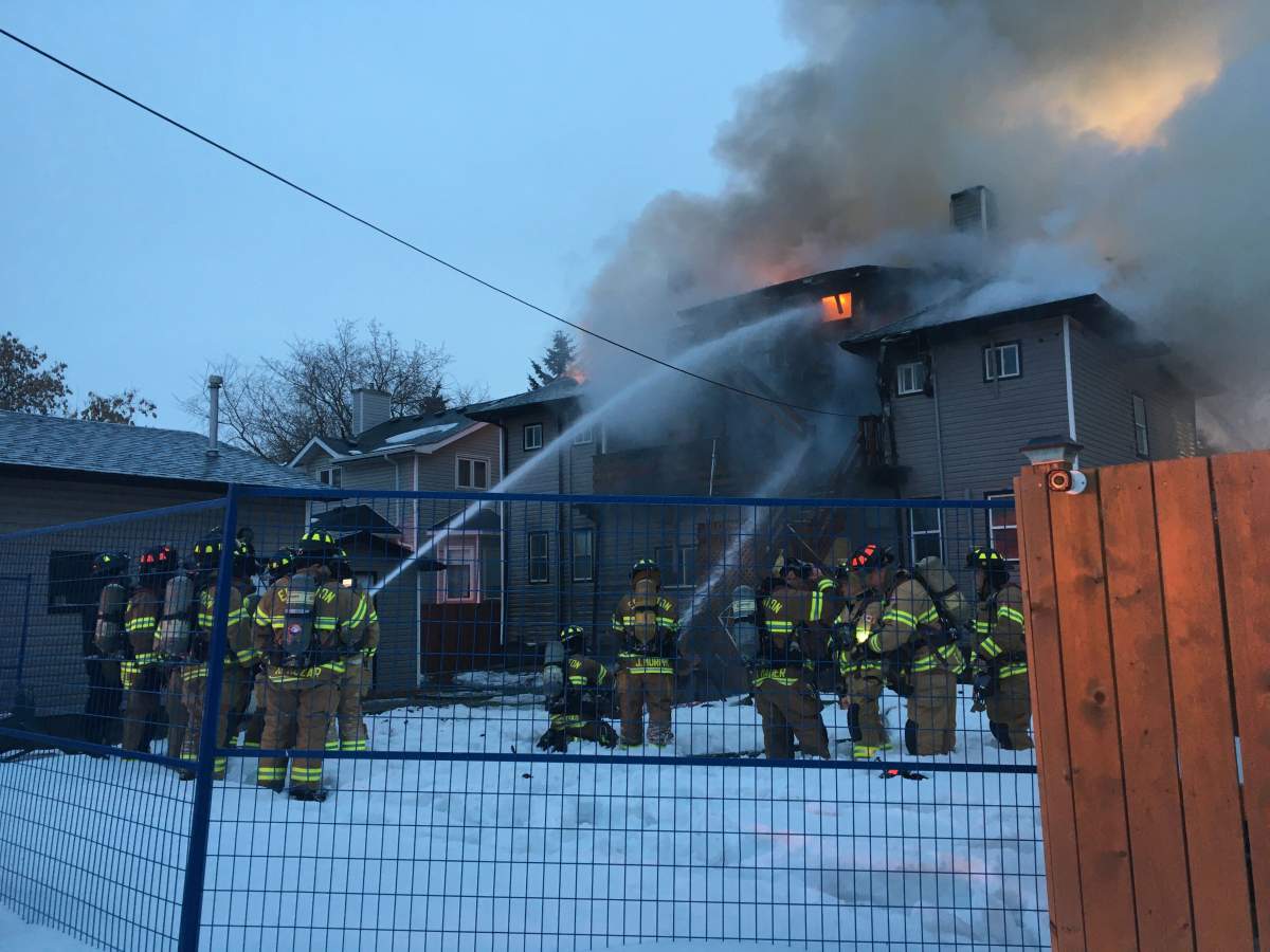 Edmonton Fire Rescue Services crews working to contain a house fire at at 110 Avenue and 123 Street in west-central Edmonton’s Westmount neighbourhood. Thursday, March 12, 2020.
