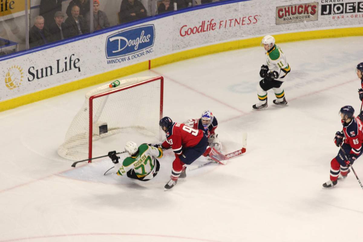 London, Ont. - Matvey Guskov of the London Knights gets dragged down going to the net in a game played at Budweiser Gardens during the 2019-20 season.