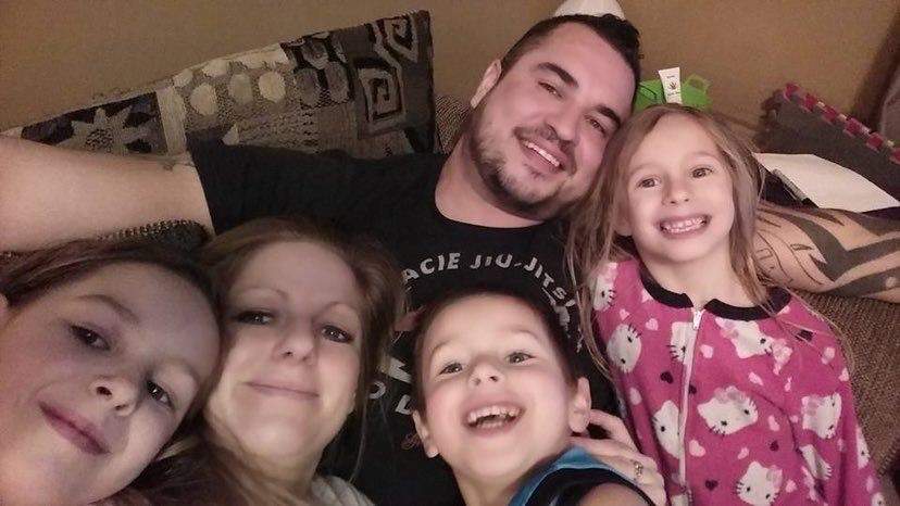 Jacob Sansom and his family shown smiling in a recent photo.