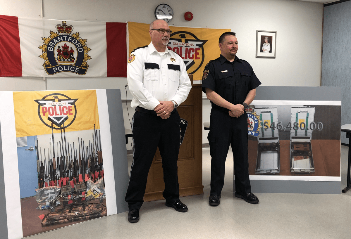 Six Nations Police inspector Darren Montour (left) and Brantford Police Chief Rob Davis (right) announced that two Ohsweken men are facing hundreds of charges in connection with three dozen ATM thefts across southern Ontario.