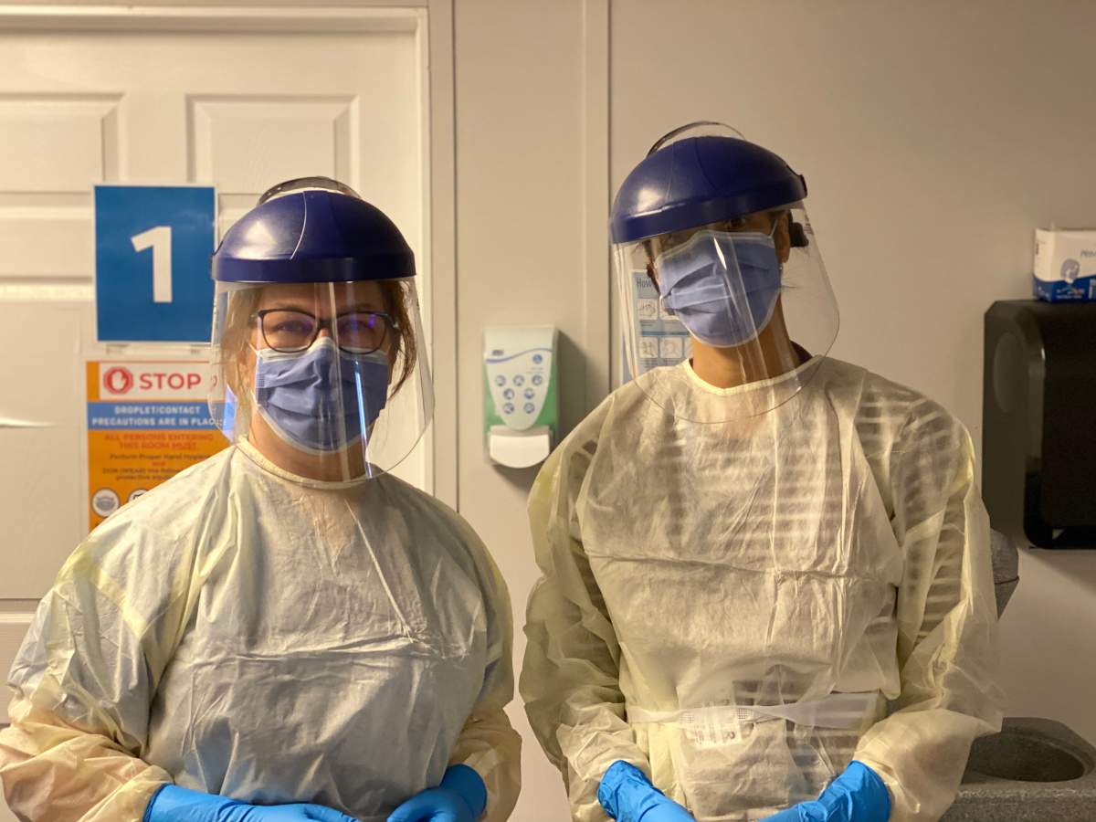 Jane Philpott (left) and a fellow health-care worker helping at Markham Stouffville Hospital's COVID-19 assessment centre. 