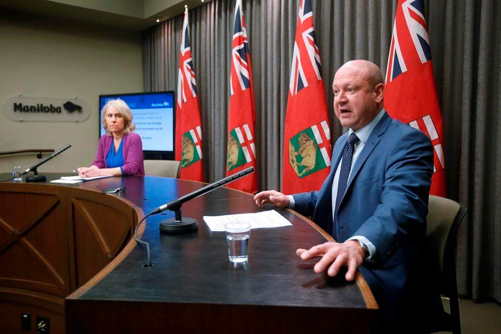 Dr. Brent Roussin, Manitoba chief public health officer, and Lanette Siragusa, provincial lead, health system integration, quality/chief nursing officer for Shared Health, speak during the province's latest COVID-19 update at the Manitoba legislature in Winnipeg Monday, March 23, 2020. THE CANADIAN PRESS/John Woods.