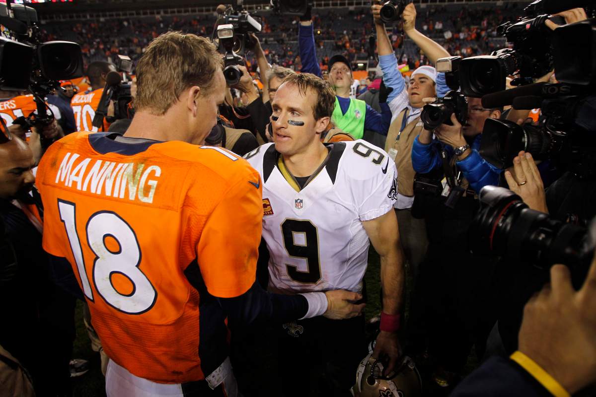 Denver Broncos quarterback Peyton Manning (18) greets New Orleans Saints quarterback Drew Brees (9) after an NFL game, Sunday, Oct. 28, 2012, in Denver.