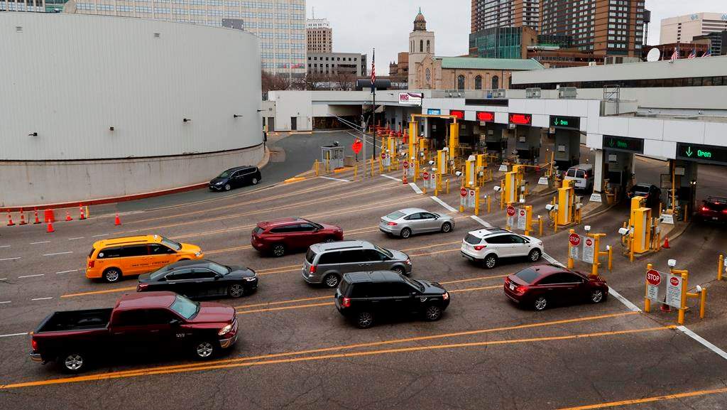 Vehicles enter the United States as a minivan drives to Canada in the Detroit-Windsor Tunnel in Detroit, Monday, March 16, 2020.