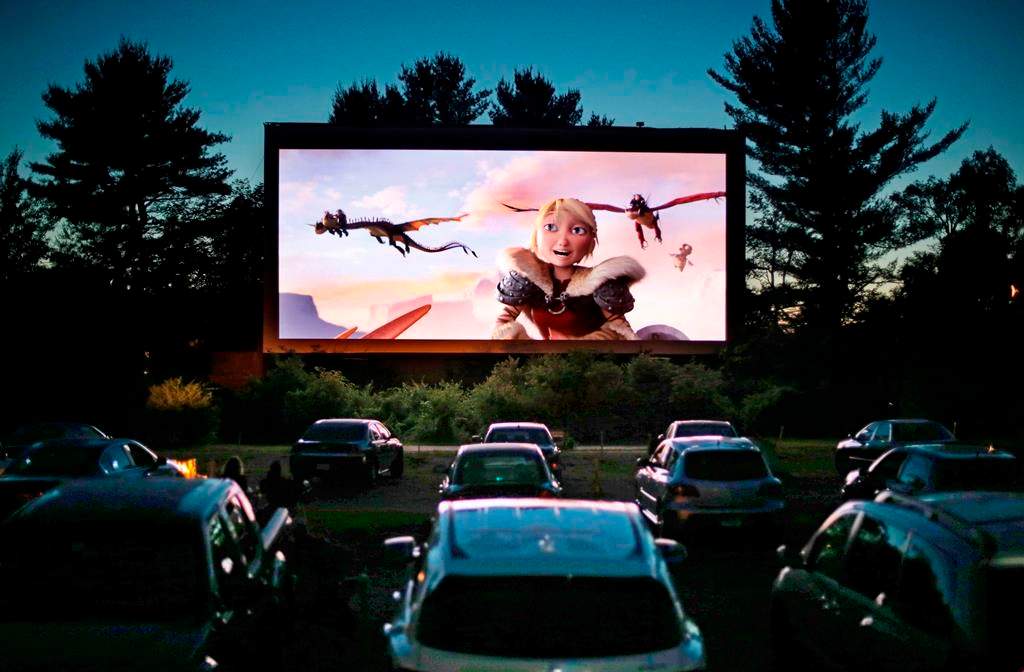 FILE - In this June 26, 2014, file photo, movie-goers watch "How to Train Your Dragon 2,".