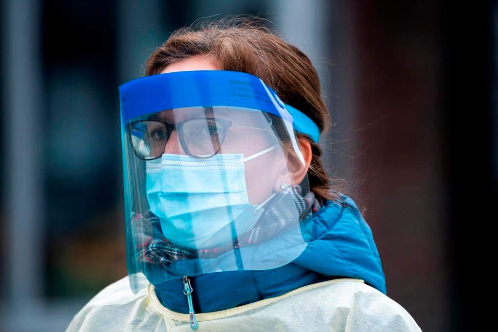 A health-care worker arrives at a walk-in COVID-19 test clinic in Montreal on Monday, March 23, 2020.