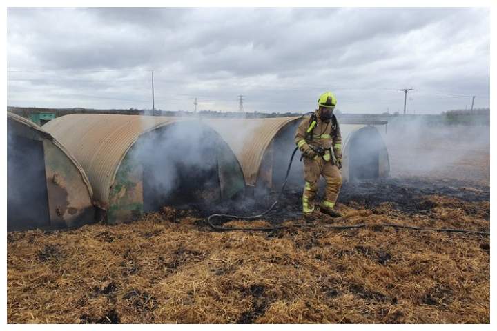 A firefighter puts out a fire on a pig farm in North Yorkshire, England, on March 7, 2020.