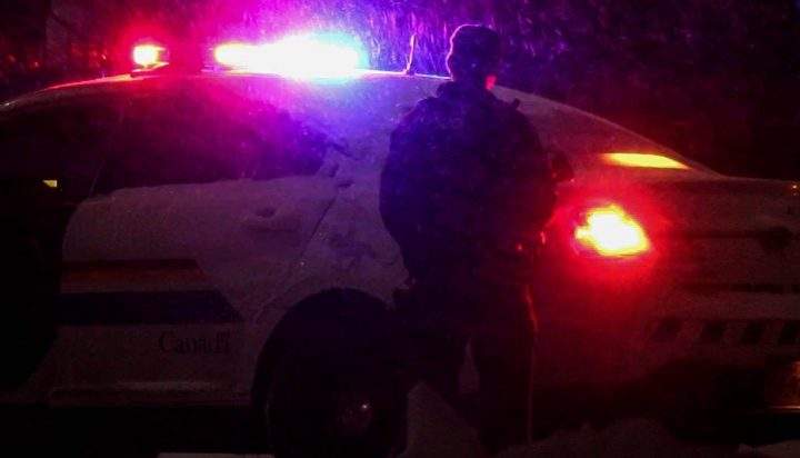 Heavily-armed police officers respond to a robbery in Moncton, N.B., on March 2, 2020. 
