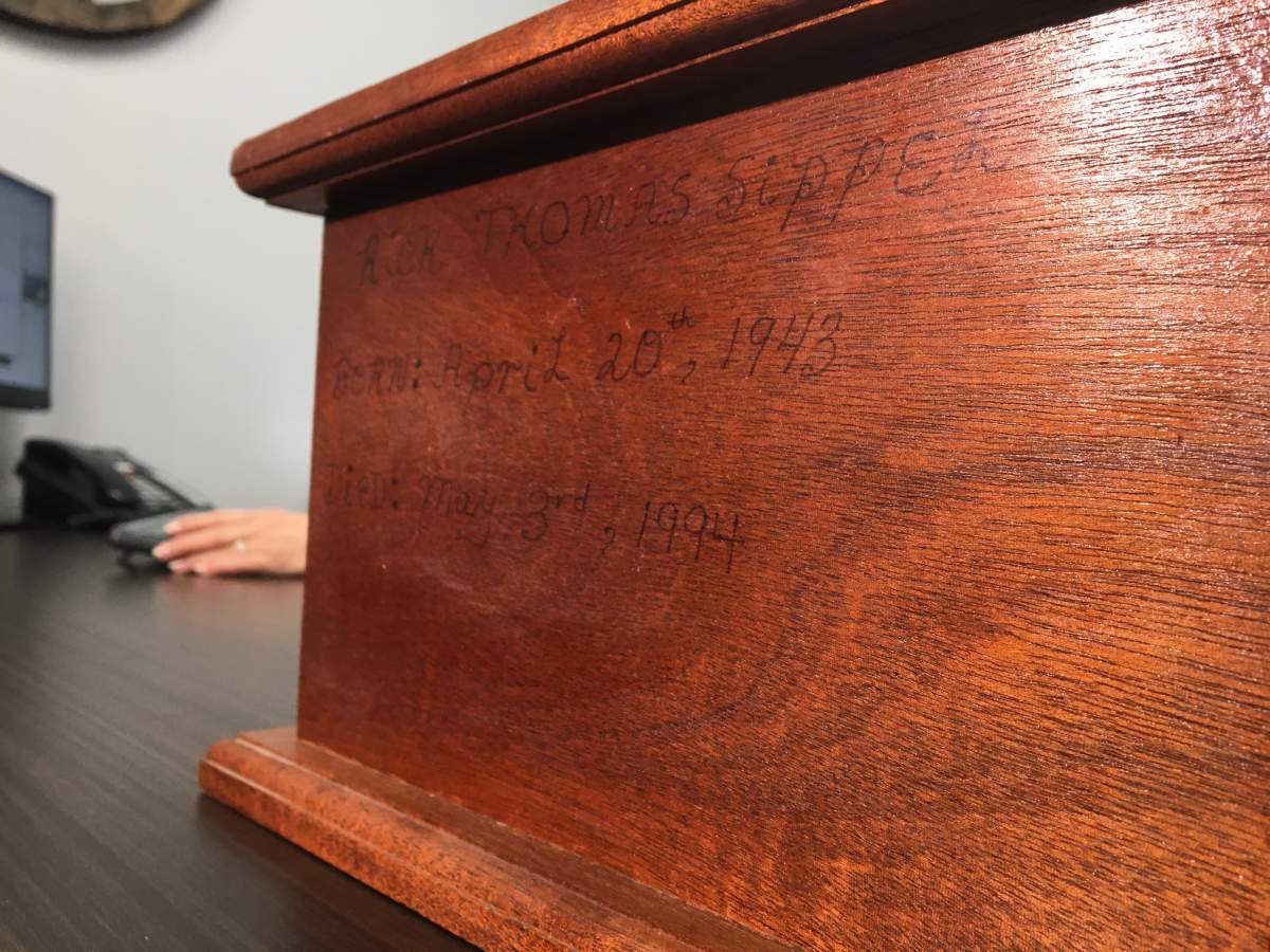 Memorial box with faded ink marks.