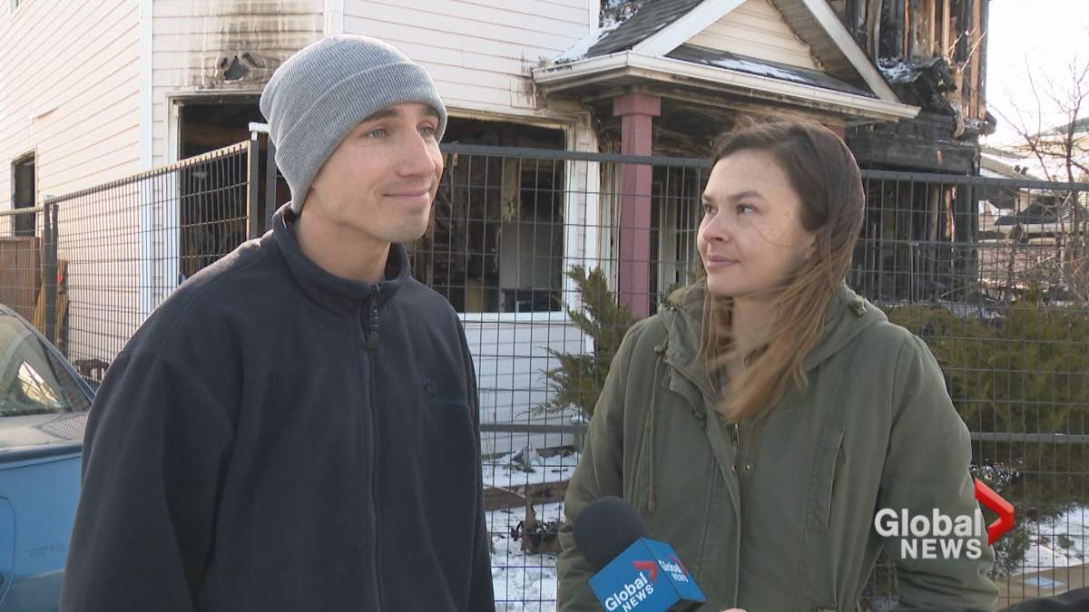 Joseph Squance and Laura Wilson in front of their burned out home in Calgary’s Riverbend neighbourhood.