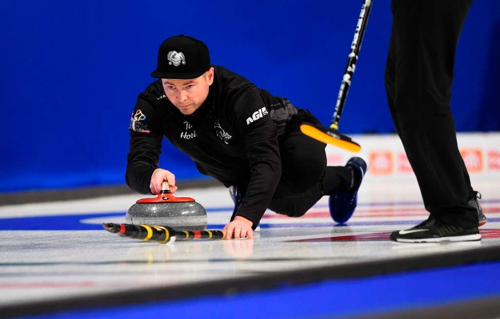 Team Wild Card skip Mike McEwen throws as he takes on Team Yukon at the Brier in Kingston, Ont., on Sunday.
