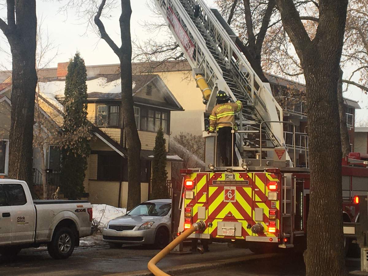 Fire crews battle a blaze at an unoccupied house on 83 Avenue between 100 and 101 streets Friday, March 27, 2020.